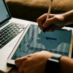 person writing on white paper