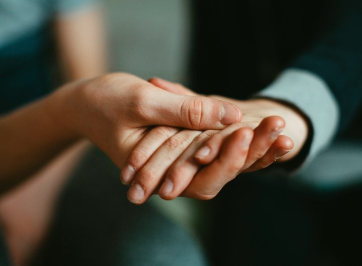 person holding babys hand